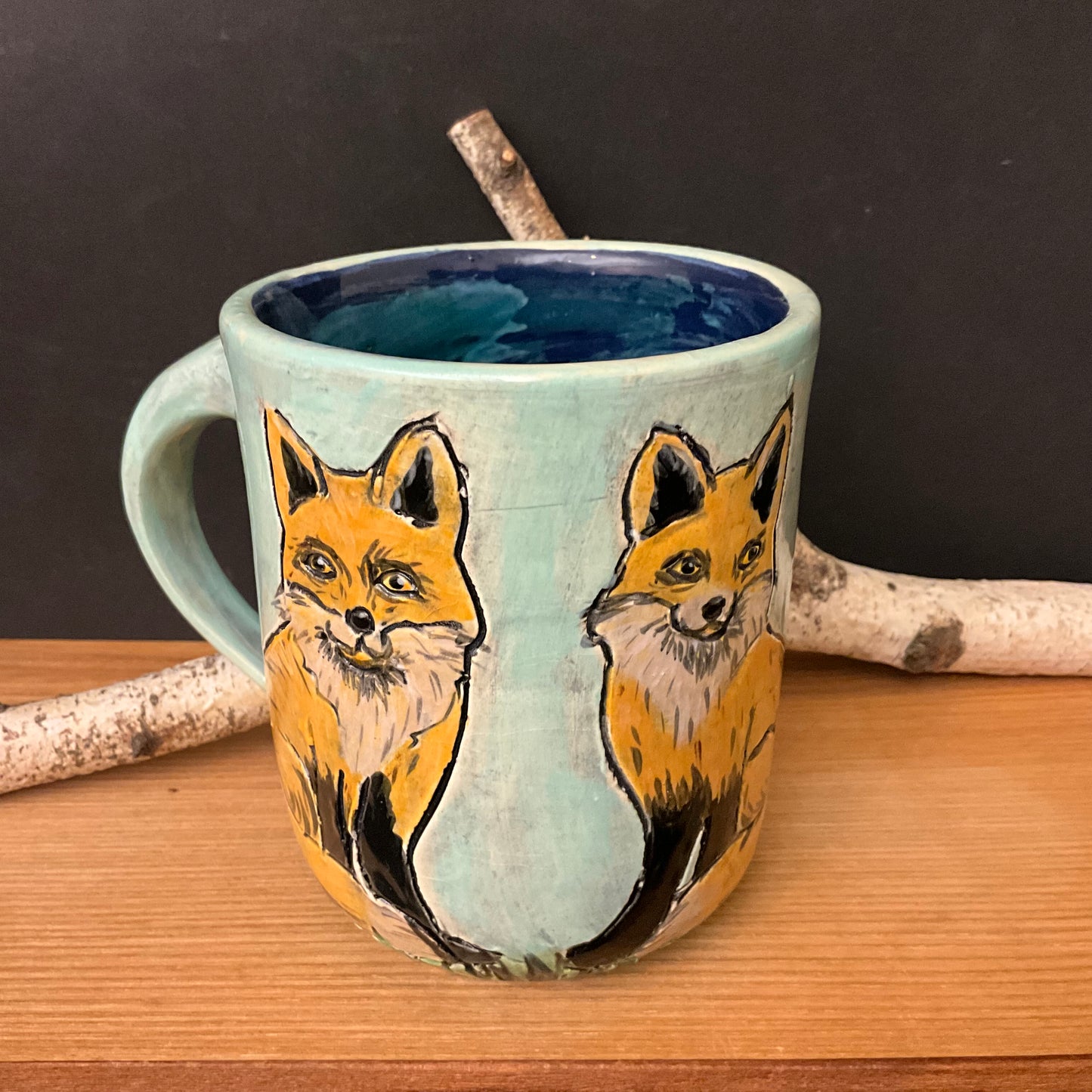 Mug with Carved Foxes