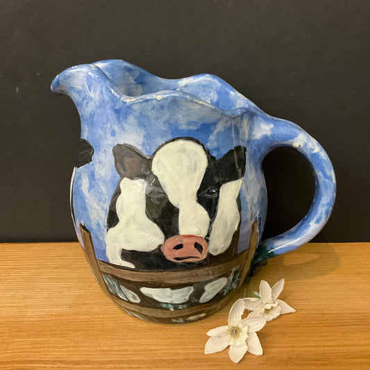 Pitcher with Holsteins on Blue Background