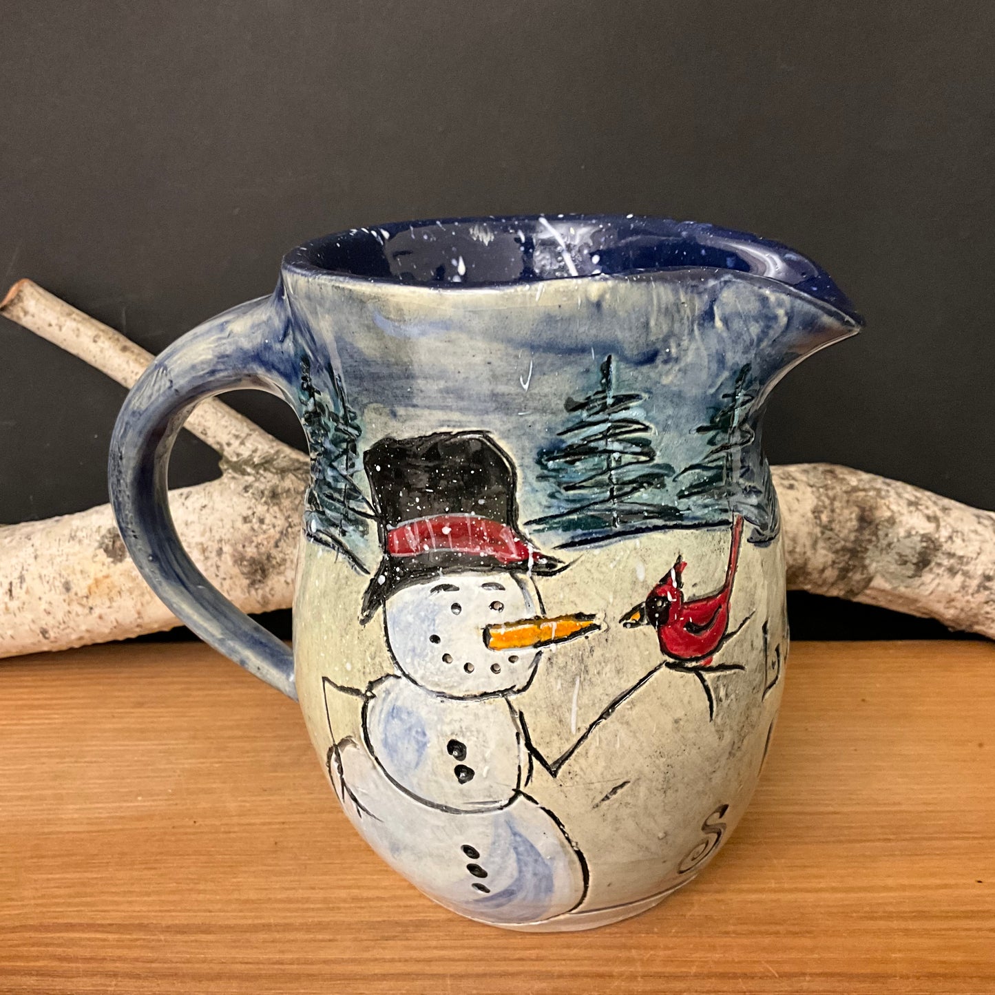 Pitcher with Carved Snowman, Cardinal, Blue Sky & Trees