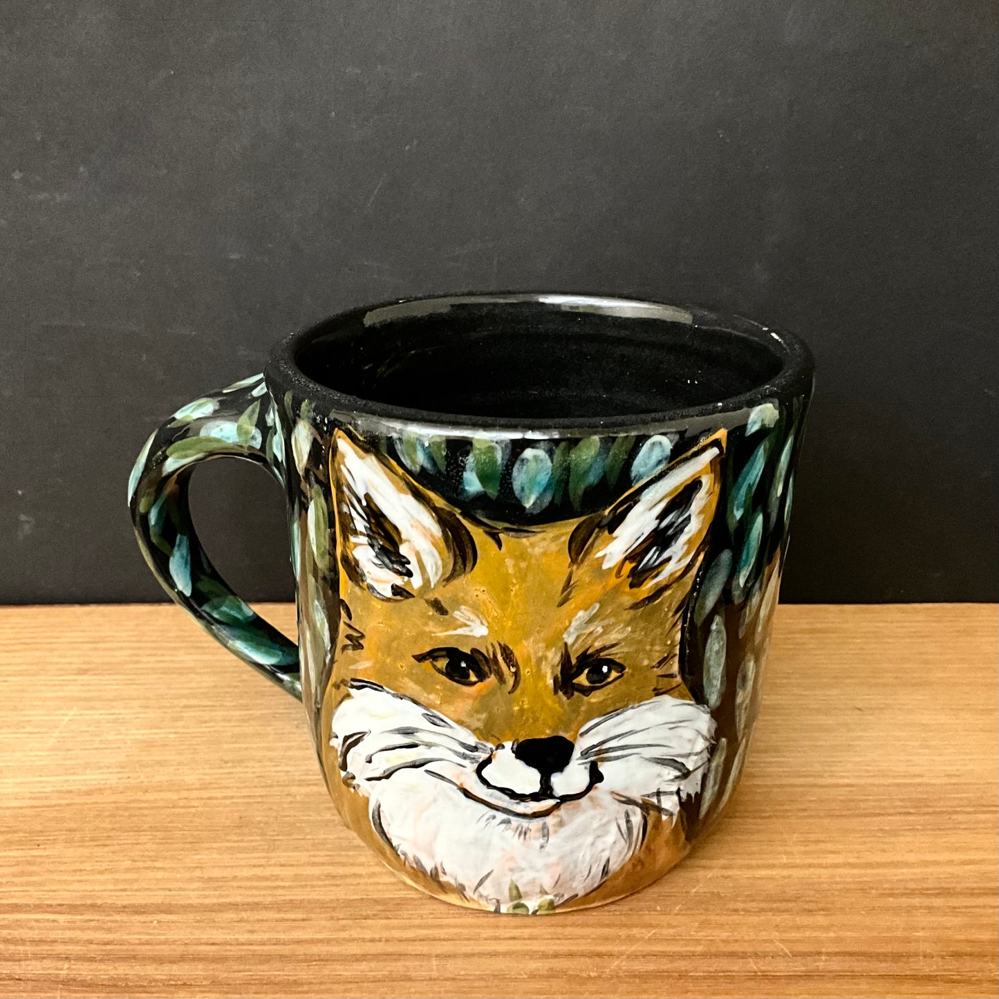 Petite Mug with Carved Fox Heads and Black Background