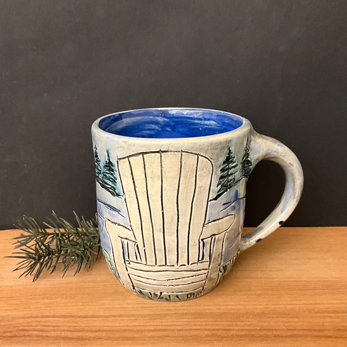 Carved Mug with White Adirondack Chair and Evergreen Trees