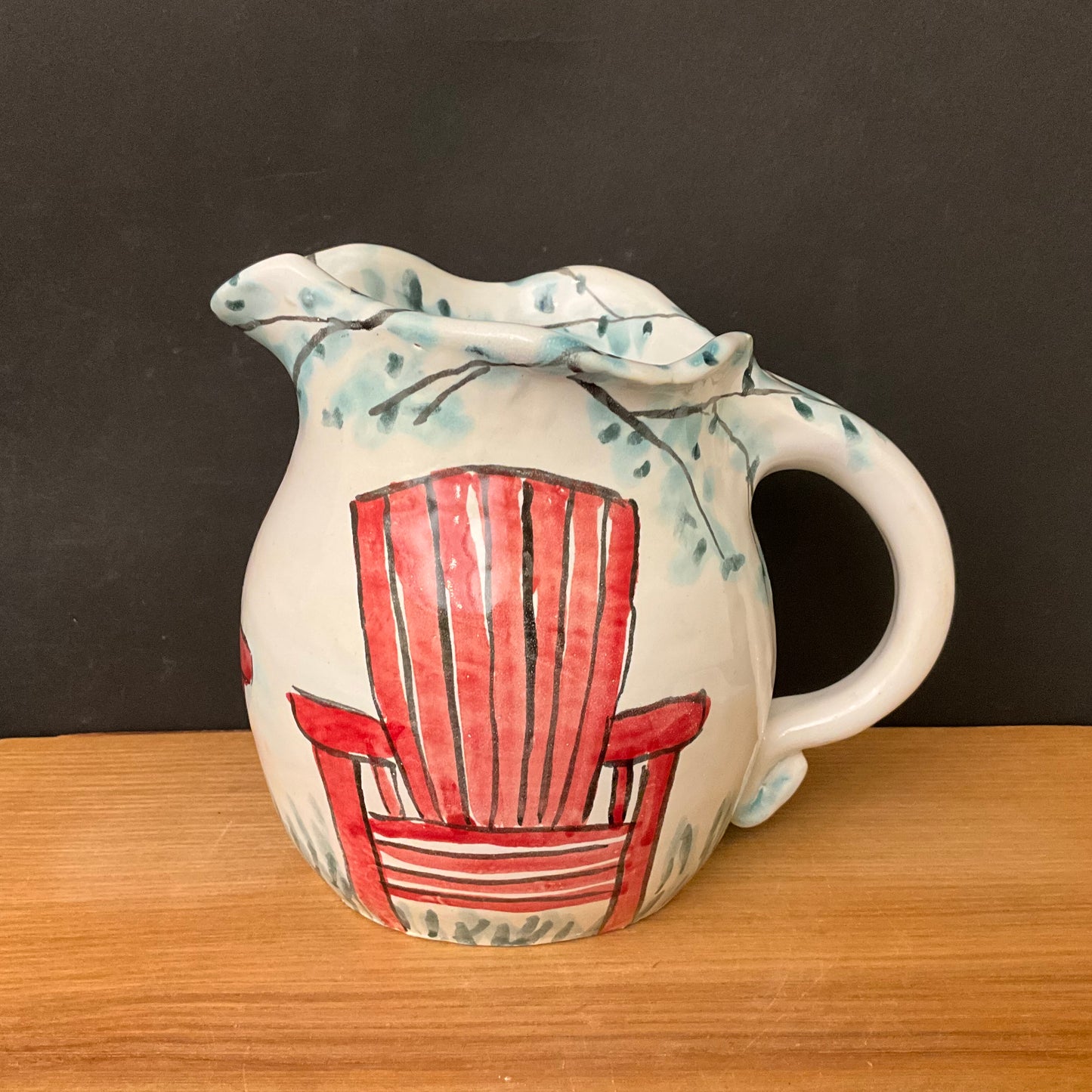 White Pitcher with Red Adirondack Chairs