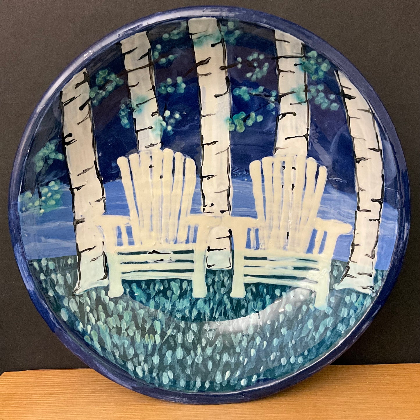 Blue pie plate w White Adirondack chairs