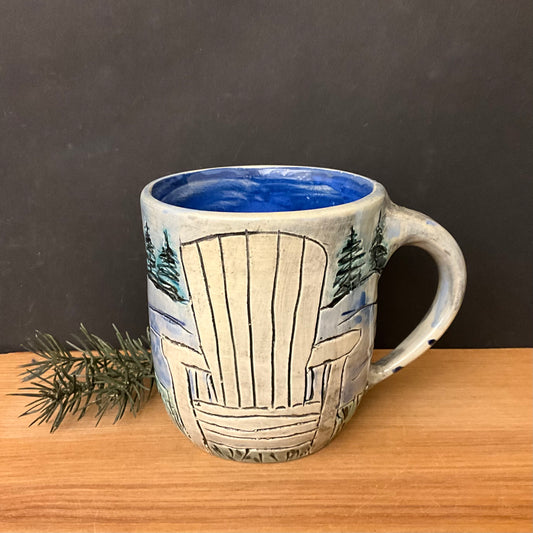 Carved Mug with White Adirondack Chair and Evergreen Trees