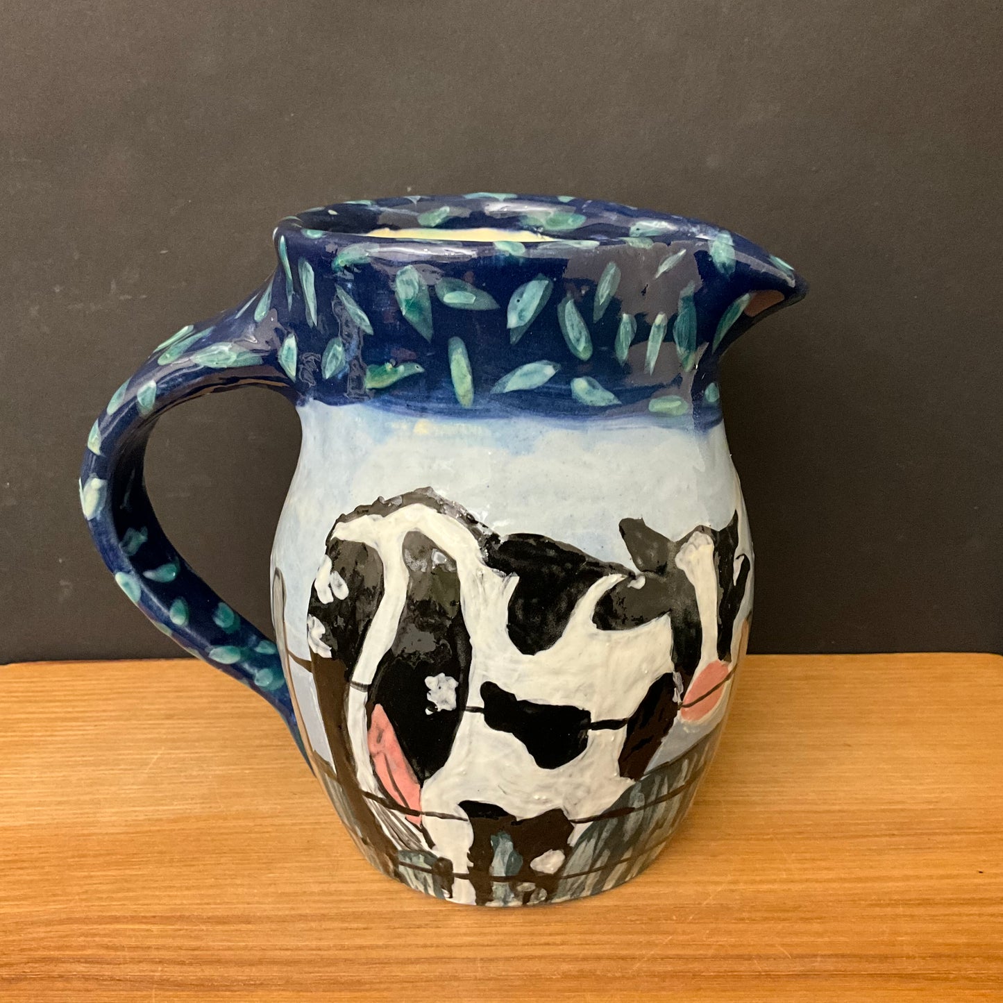 Pitcher with Holsteins on the Fence