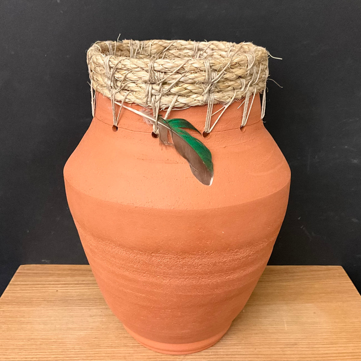 Large Red Earthenware Vase with Woven Rim and Feather